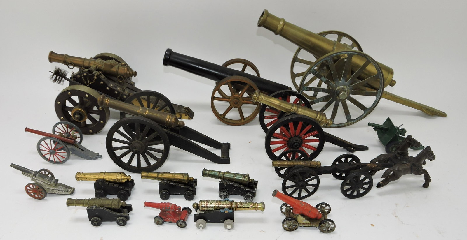 Lot of 16 iron, brass, and metal cannons: .