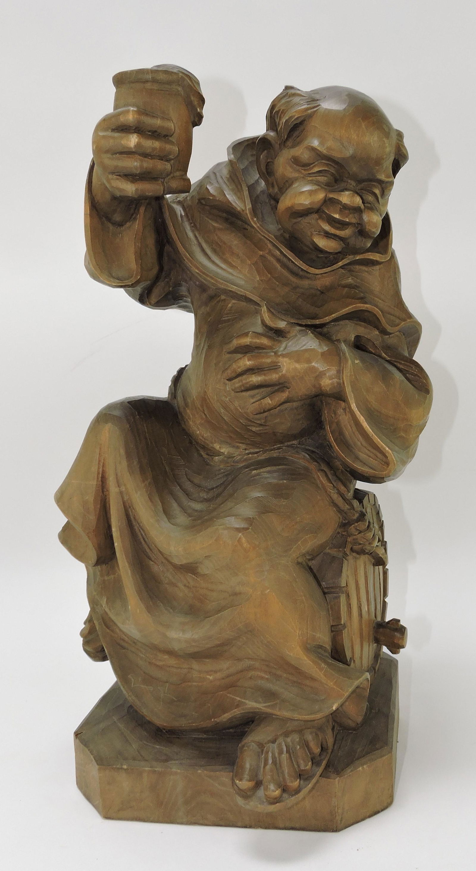 Carved wooden figure of monk atop (1 of 1)