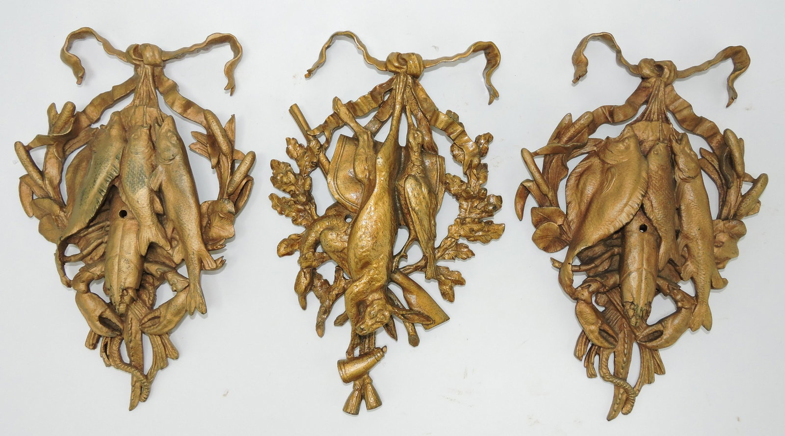Lot of 3 cast brass pediments, two: with fish atop bed of cattails, the other a game bird and rabbit with gun with oak leaves and acorns, 10"