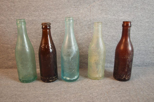 Lot of 5 early Coca Cola bottles - amber from Spr: Lot of 5 early Coca Cola bottles - amber from Springfield, OH and Knoxville, TN, 2 green from Battle Creek, MI and irredescent from Jacksonville, FL