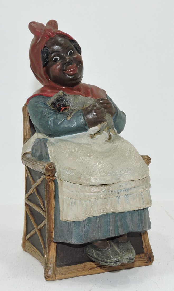 Black Americana terra cotta humidor of woman: with puppy seated in chair, 8 1/2" signed J.M.