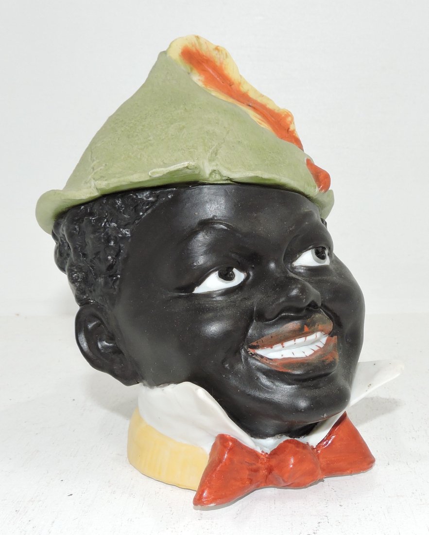Black Americana porcelain humidor of man's: head, 6 18/2", chips to inside of lid