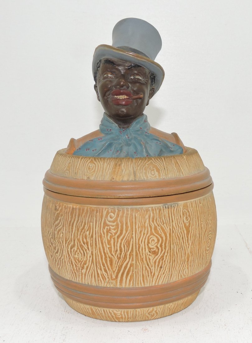Black Americana terra cotta humidor: of man in barrel, 8", signed J.M.