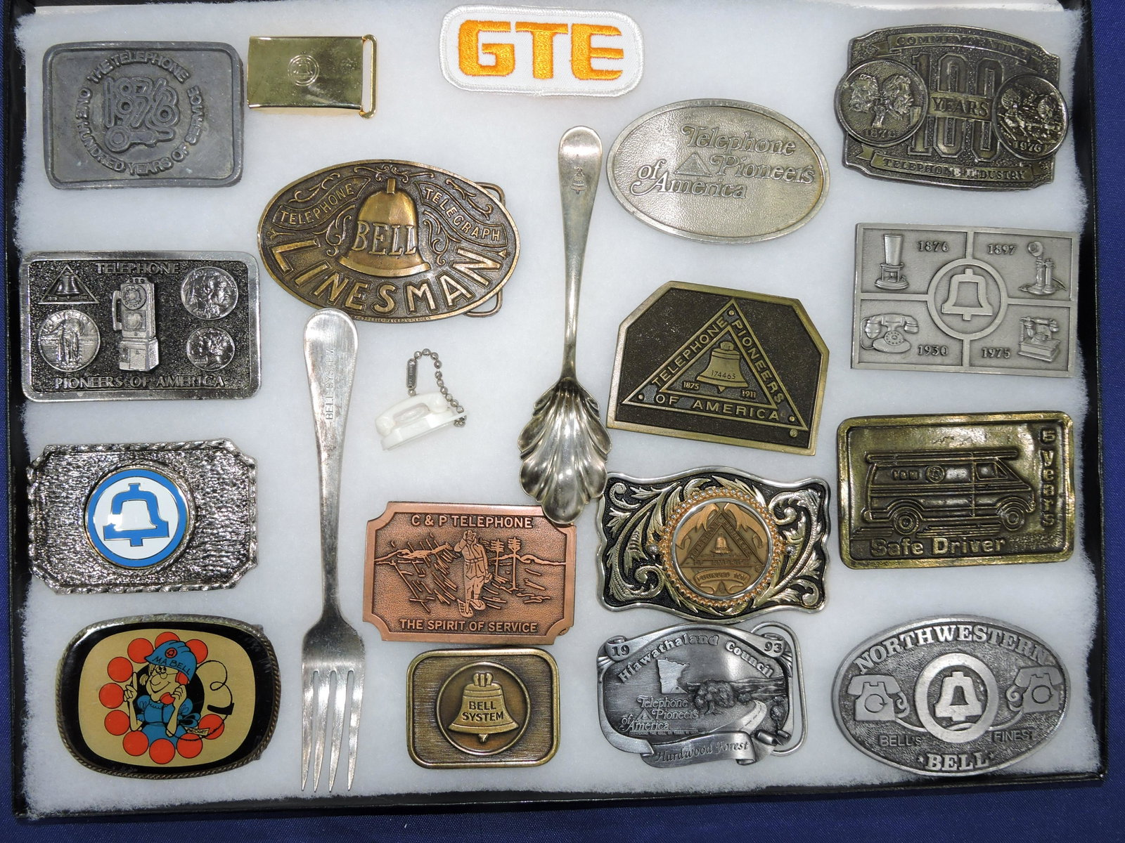 Lot of telephone related belt buckles: and 2 Bell Systems flatware pieces