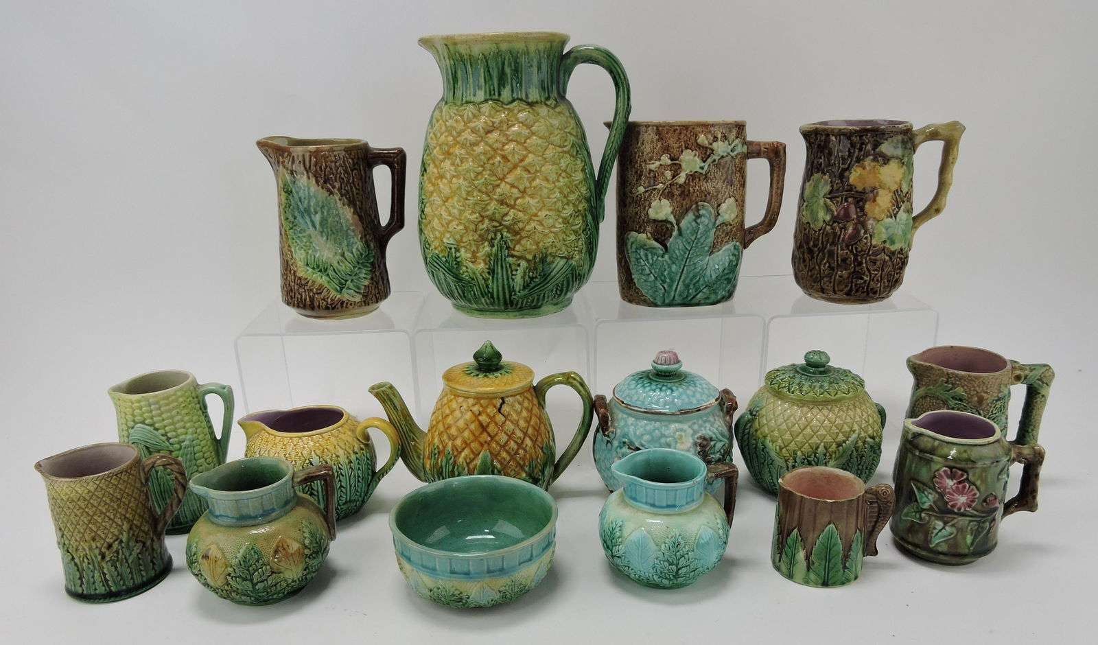 Majolica lot of 16 pitchers, creamers,: sugars, and teapot; various condition