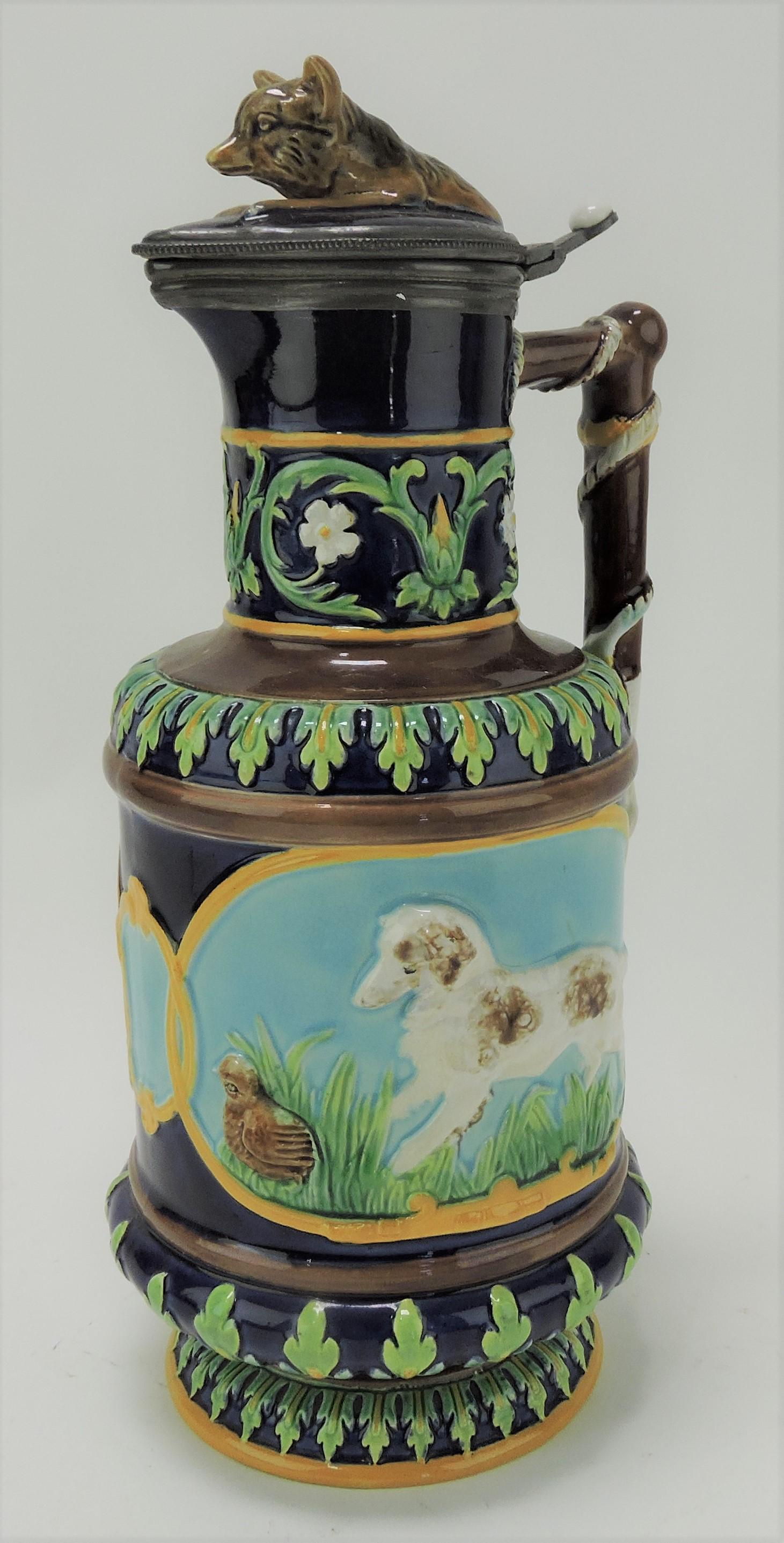 George Jones majolica hunt wine ewer: with fox on cover and panels of dog with quail and fox with rabbit, 11 1/2", professional lid repair