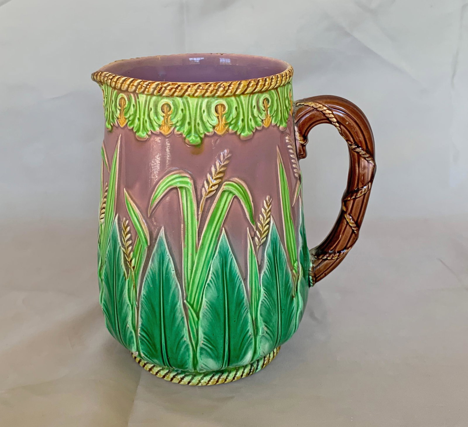 George Jones majolica pink wheat: pitcher, body decorated with wheat and acanthus leaves and yellow rope twist rims, 7"h