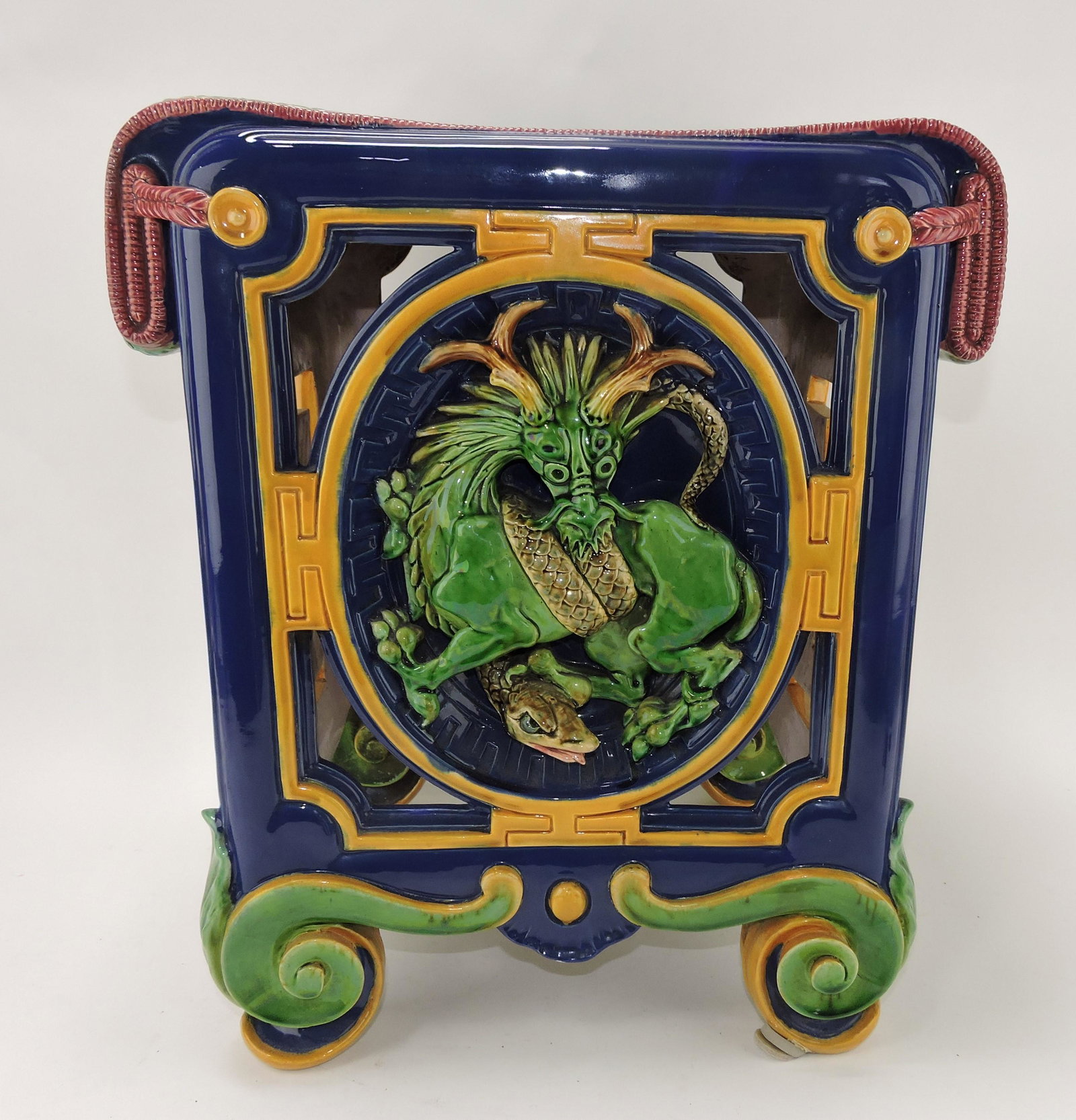 Minton majolica garden seat with: Chinese dragon and snake, shape no. 786, 18"h, 16"w, 14"d, professional hairline repair to seat and side