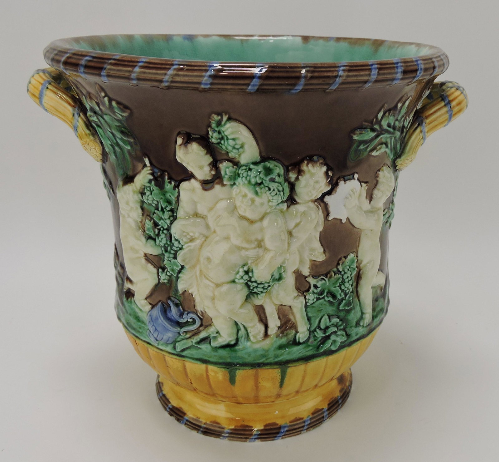 Wedgwood majolica wine cooler with: mythological figures, 9 1/2"h, 10 1/2"w, base repair