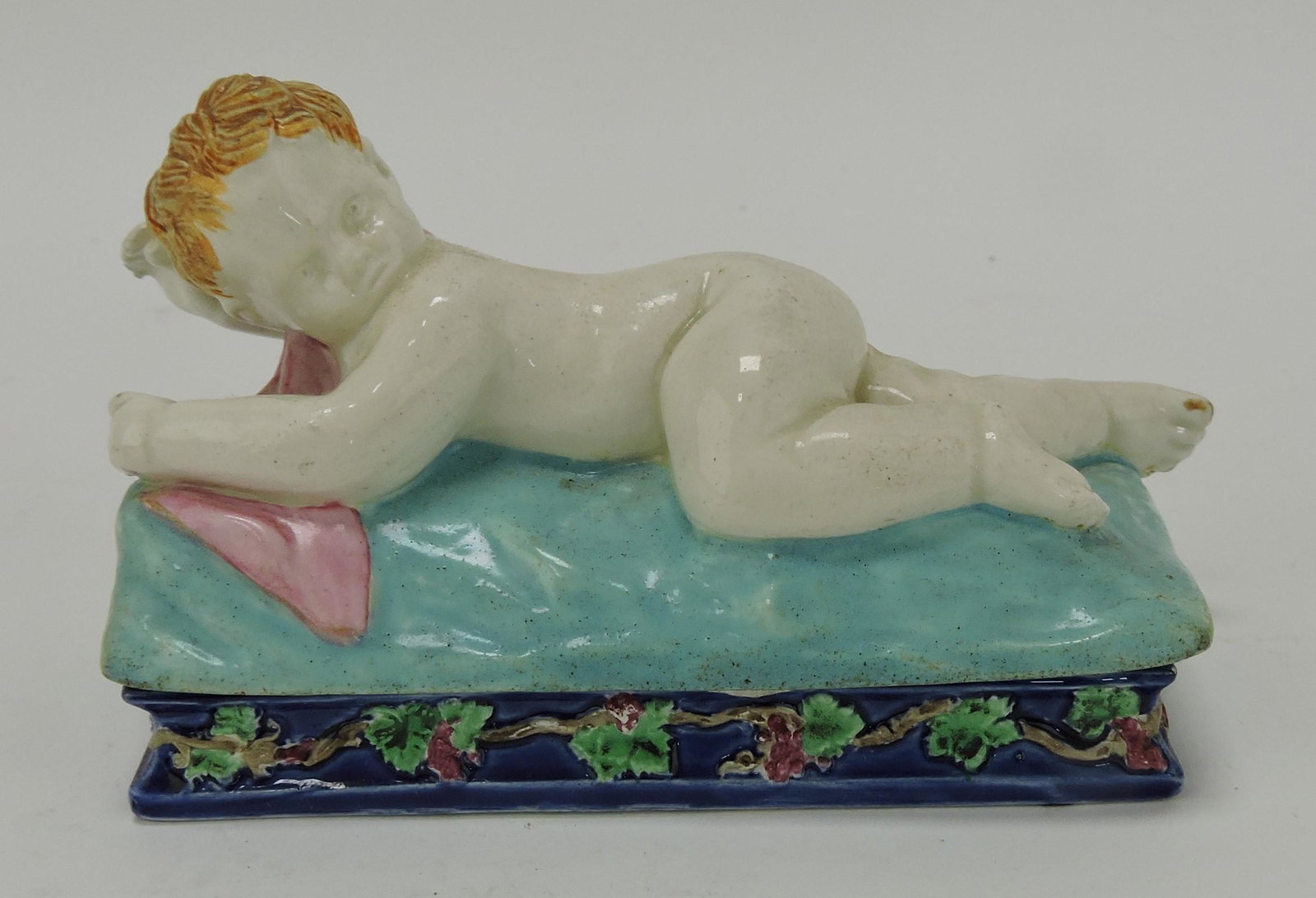 Wedgwood majolica rare trinket box: with reclining boy, 4 3/4"l, 2 1/2"h, ref. Dawes p.98