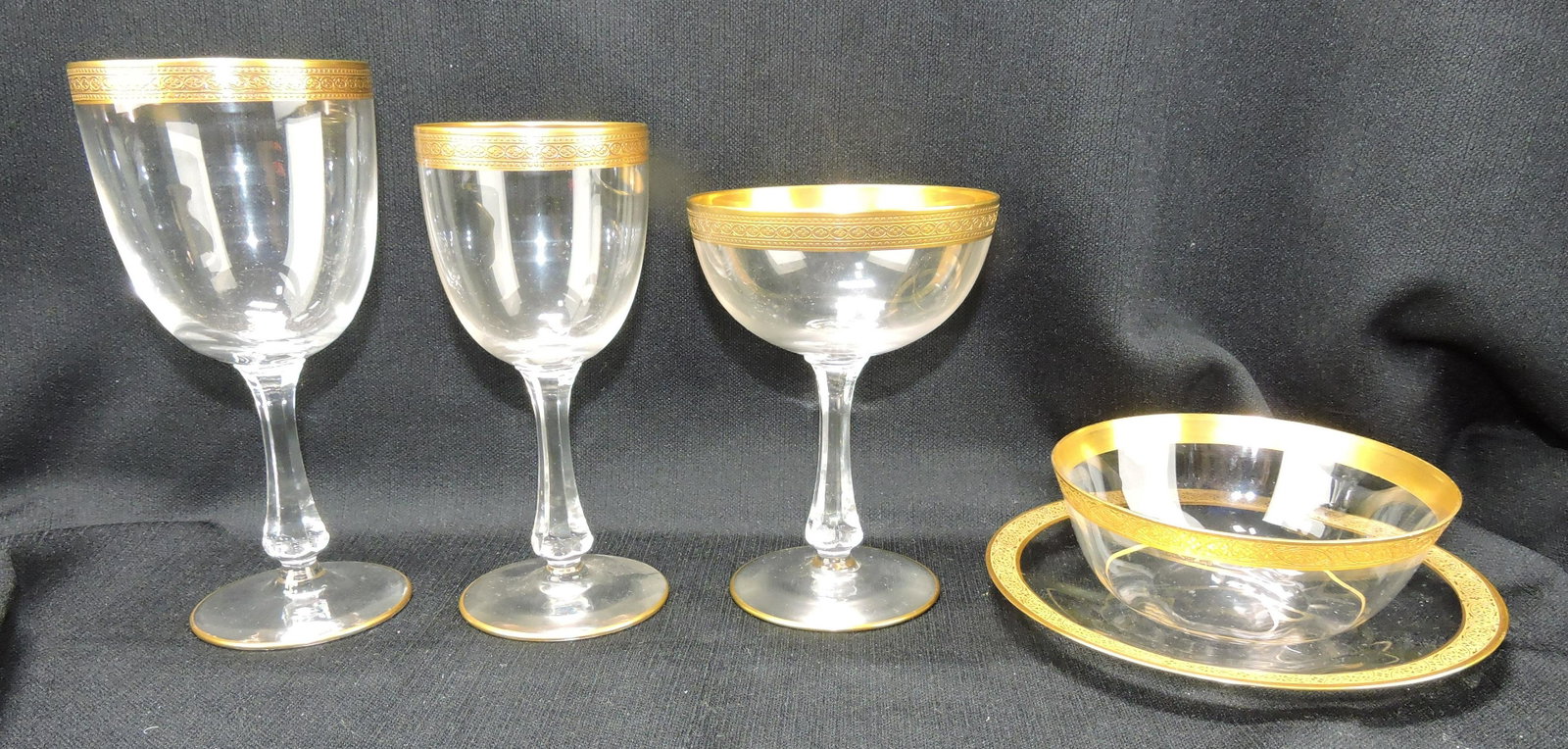 Set of gold rimmed stemware:: 14 - 7" water goblets, 11 - 6 1/4" wine goblets, 1 - 5 /12" champagne, 10 - 4 3/4" bowls, 10 - 6 1/4" plates