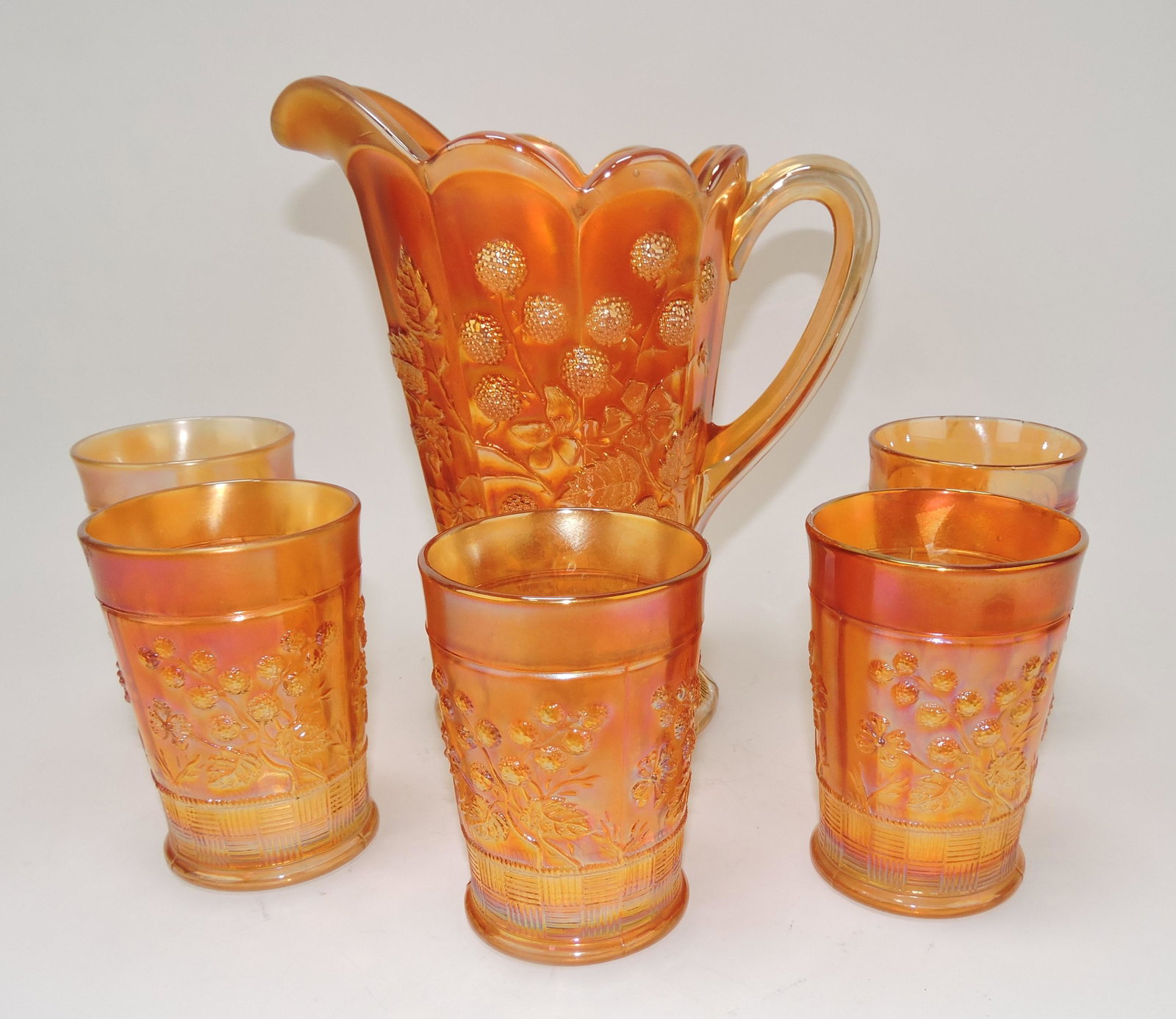 Northwest marigold carnival glass: Raspberry pitcher and 5 tumblers (minor nick to one tumbler)