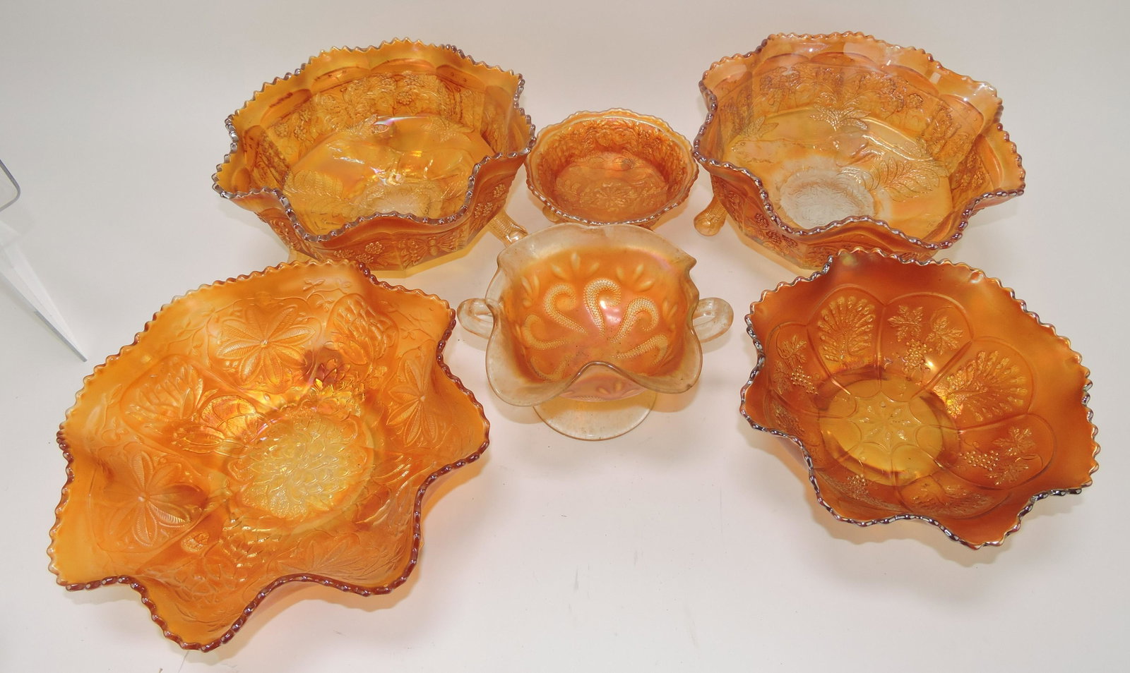 Carnival glass lot of 6 marigold: pieces: 2 large and 1 small panther bowls, peacock and grape bowl, water lily bowl, and question mark compote