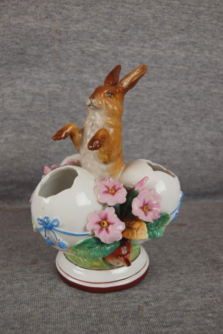KPM porcelain figure of a rabbit with three eggs,: KPM porcelain figure of a rabbit with three eggs, nicks to flowers, 6 1/2"