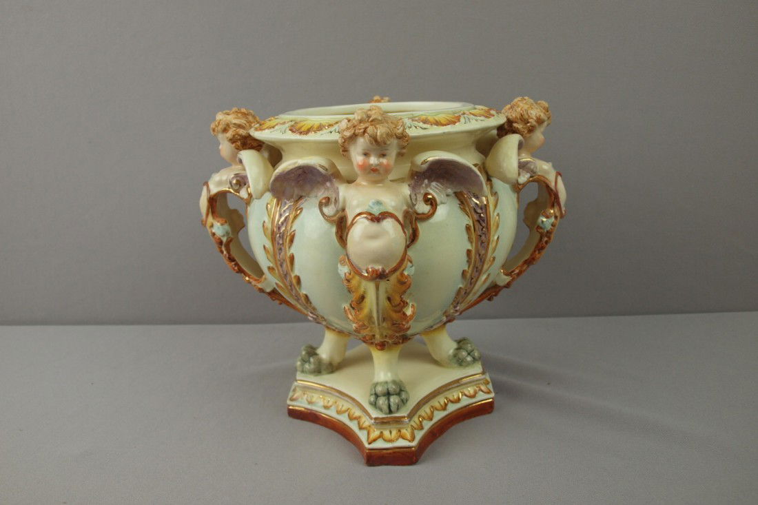 HUGO LONITZ jardiniere with 4 winged angels and pa: HUGO LONITZ jardiniere with 4 winged angels and paw feet, repair to wings, 9 1/2", signed with double fish mark