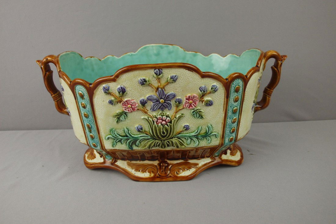 Large French oval two handled jardiniere with flo: Large French oval two handled jardiniere with floral motif, chip to base, 18"l, 8"h