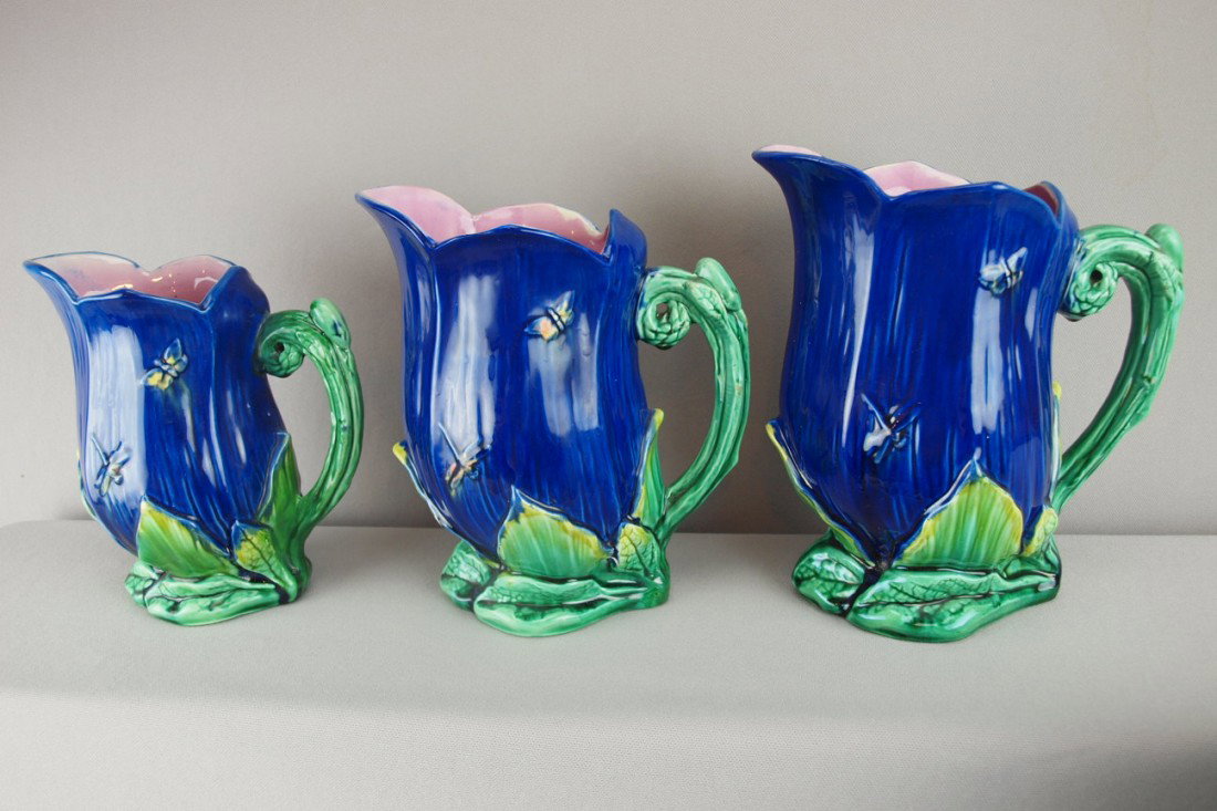 Adams & Bromley set of 3 cobalt majolica pitchers: Adams & Bromley set of 3 cobalt majolica pitchers with dragonflies and butterflies on lily base, 8 1/2", 8" and 7", all with professional hairline, rim and/or handle repair, English Registry mark, nic