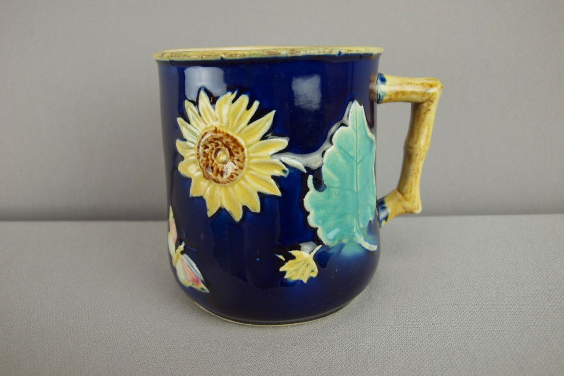 Majolica cobalt sunflower and butterfly mug with: Majolica cobalt sunflower and butterfly mug with bamboo handle, 4"