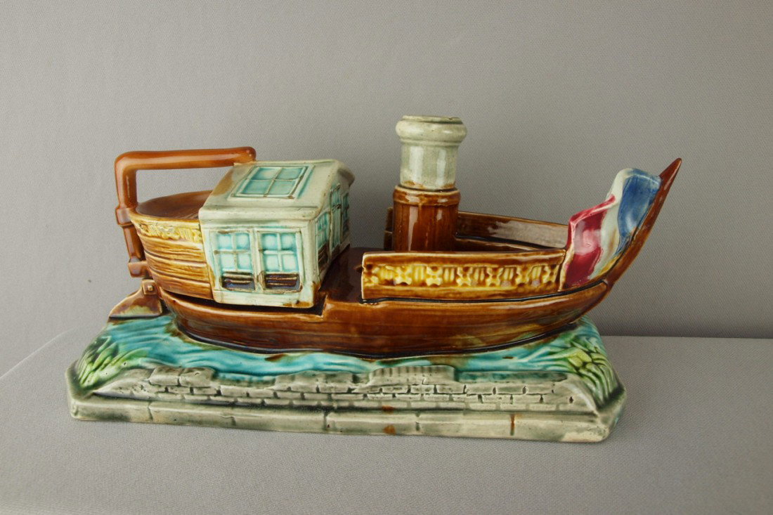 French figural tug boat humidor, cigar holder and: French figural tug boat humidor, cigar holder and match striker, professional repair to rudder handle and flag, 12 1/2"l
