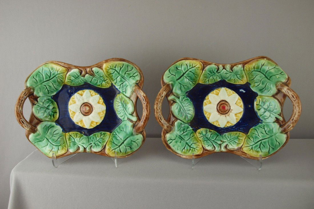 Majolica pair of platters with cobalt ground, flo: Majolica pair of platters with cobalt ground, floral center and leaf border with vine handles, 10", both with rim nicks to back