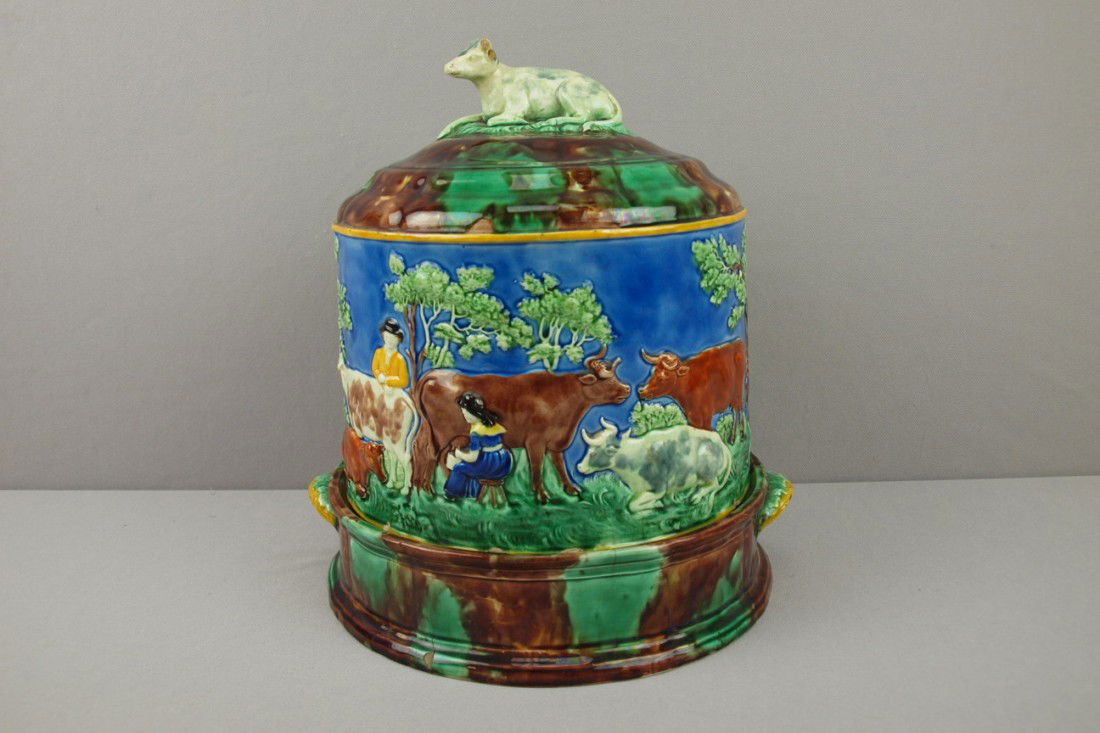 WEDGWOOD rare majolica cheese keeper with cow fin: WEDGWOOD rare majolica cheese keeper with cow finial (loss of horns) and scene of man and woman with cows in meadow on cobalt ground, base rim nicks and hairline to cover, hairlines to base, 12"h