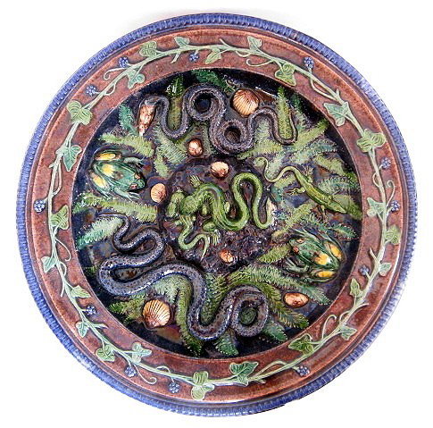 School of Paris circa 1870 French Palissy Ware ch: School of Paris circa 1870 French Palissy Ware charger decorated with two lizards in combat, flanked by snakes, frogs, a third lizard among shells and foliage, the border with berried vine within a ro