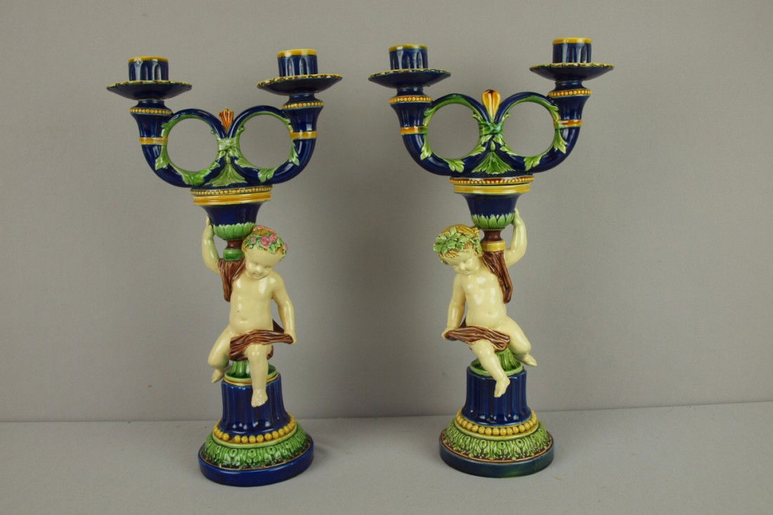 MINTON majolica very rare pair of two lite candle: MINTON majolica very rare pair of two lite candleabras with puttis, outstanding color and detail, 15"h, shape no. 1448, professional repair to rings of candle holder