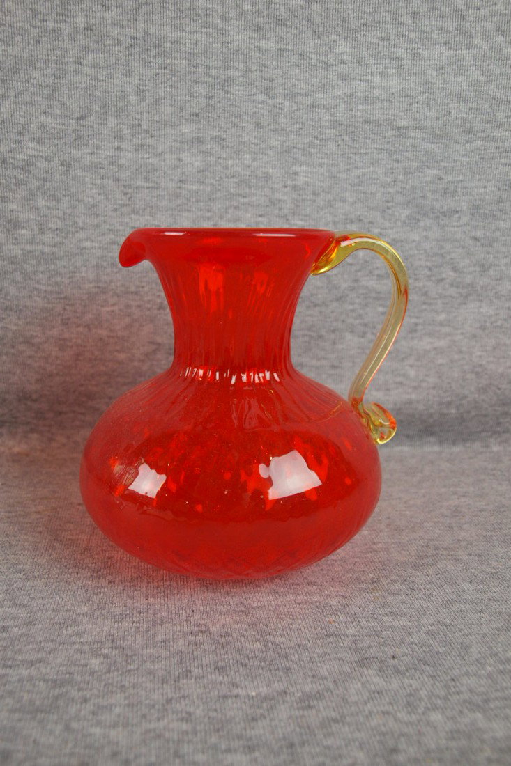 Blown orange art glass pitcher with applied yellow
