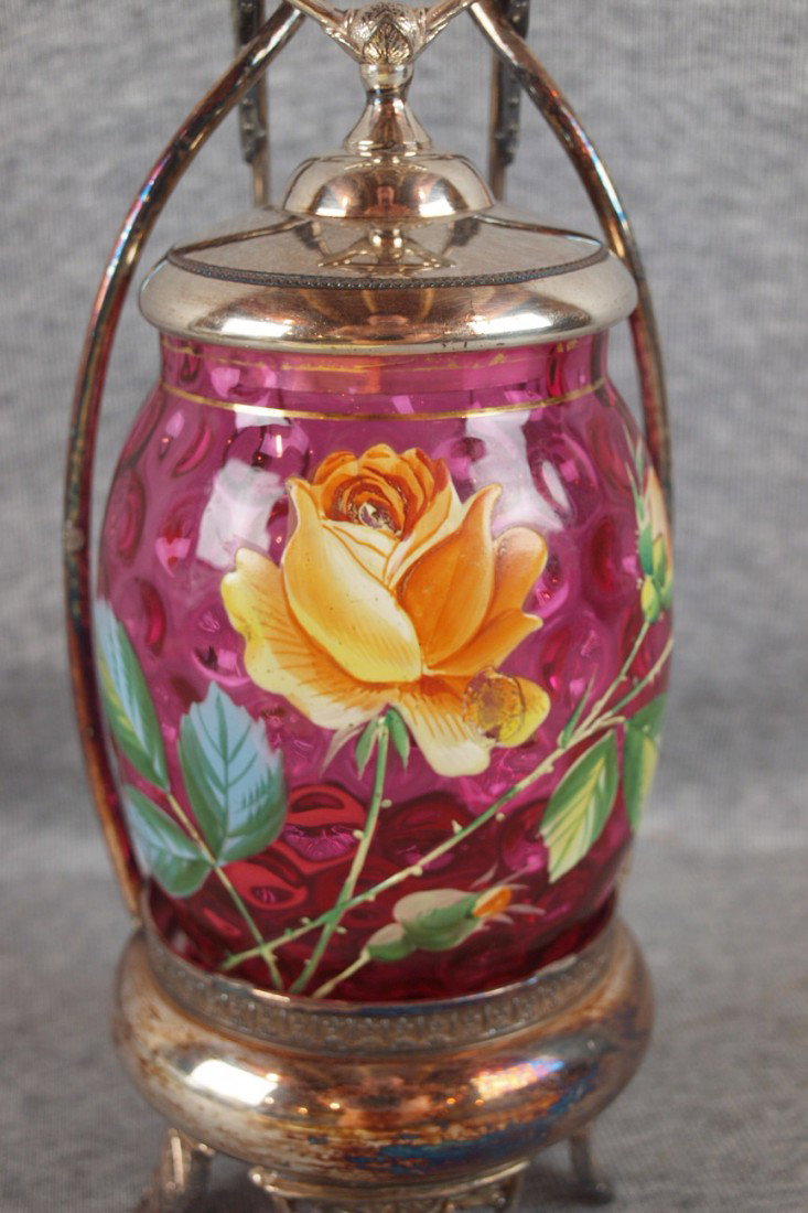 Cranberry glass pickle castor with enamel roses, 1