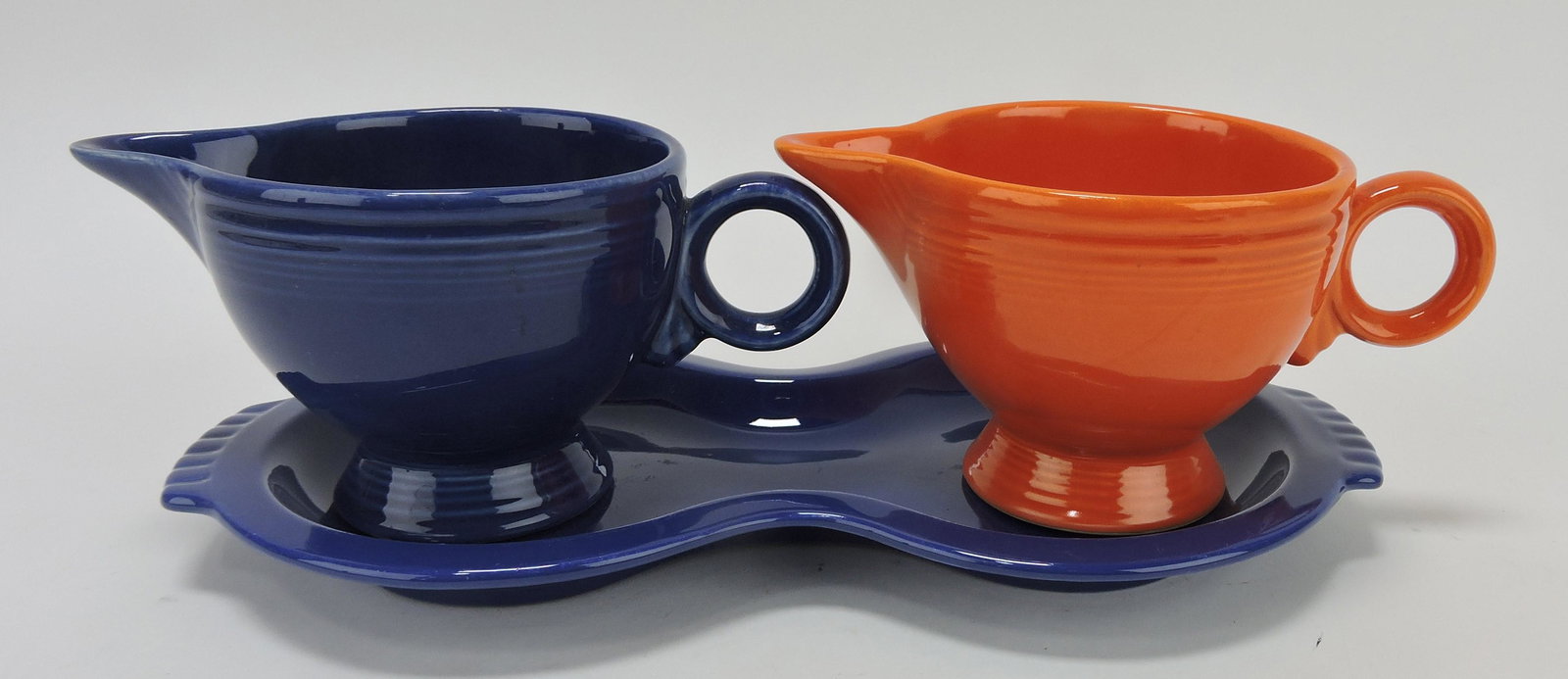 Fiesta lot of 2 creamers, red and: cobalt, and cobalt figure 8 tray