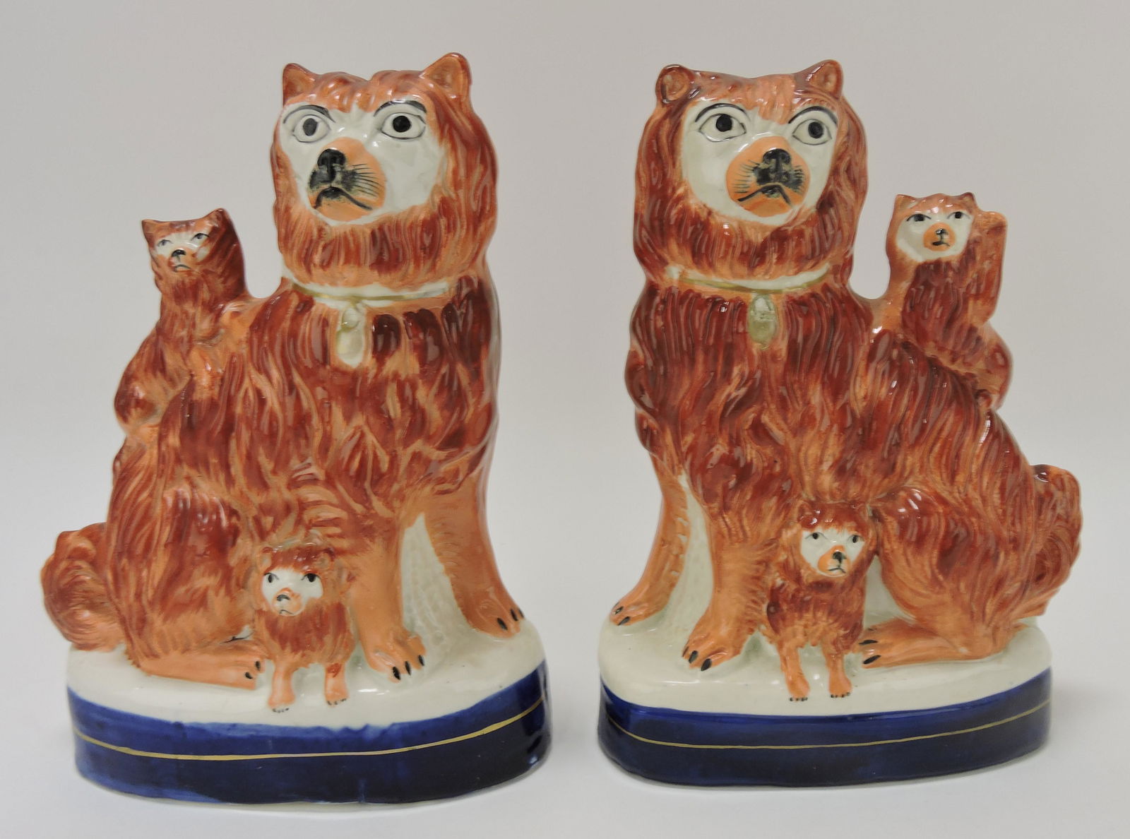 Staffordshire pair of dogs, each with (1 of 2)