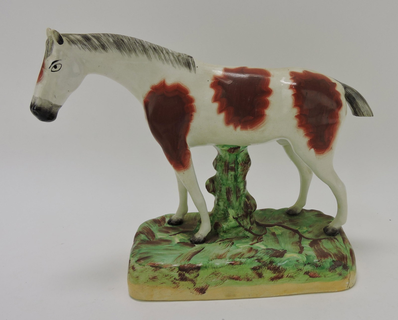 Staffordshire figure of a horse,: professional repair to ears and tail, 9"h, 12"l