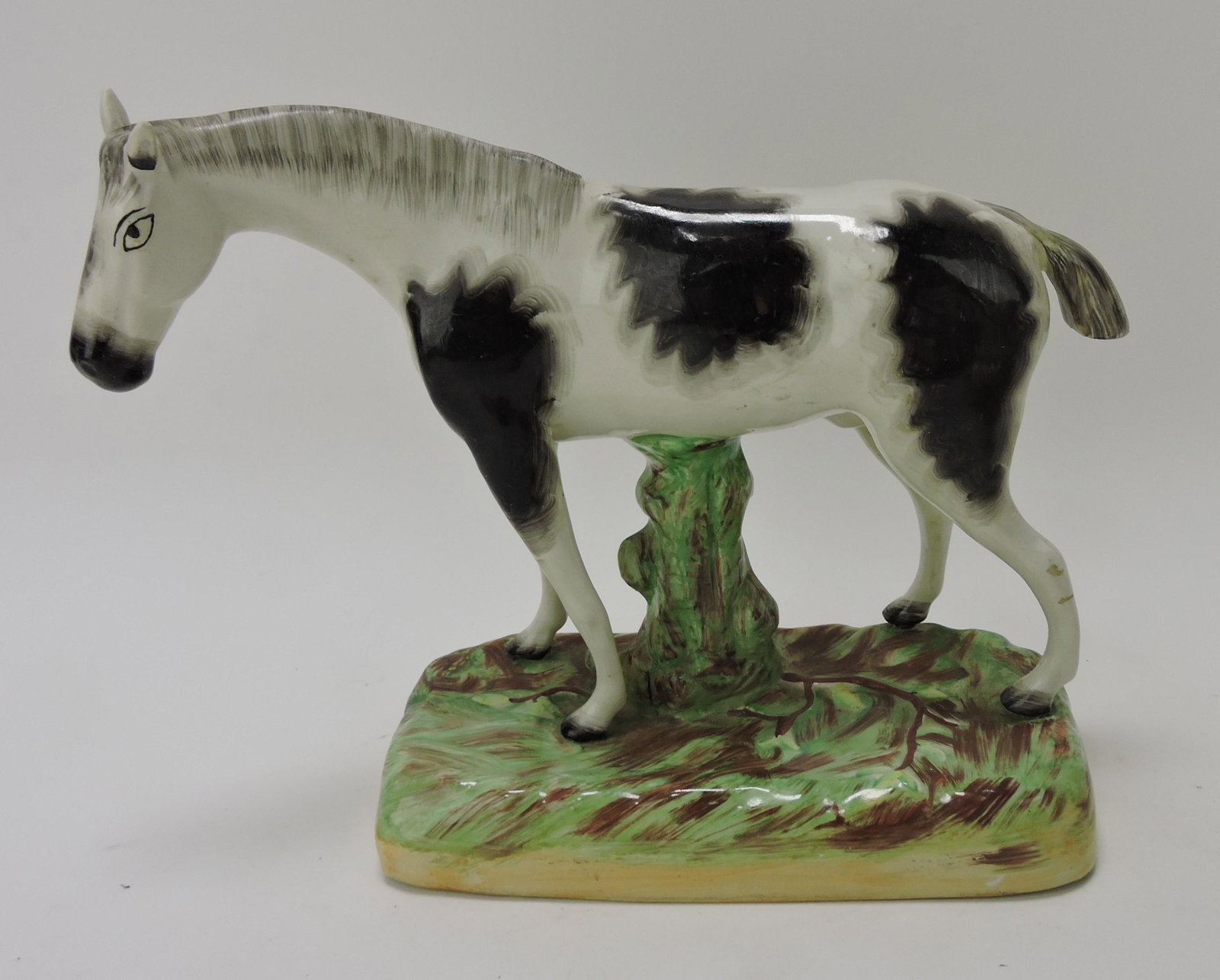 Staffordshire figure of a horse,: professional repair to tail, 9"h, 12"l