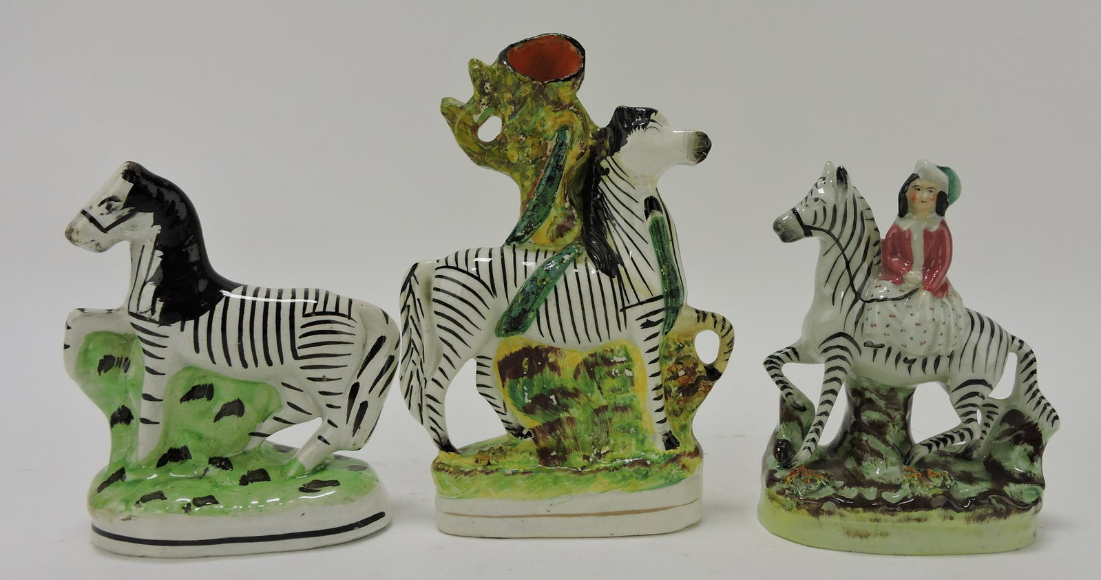 Staffordshire lot of 3 zebra figures,: various condition