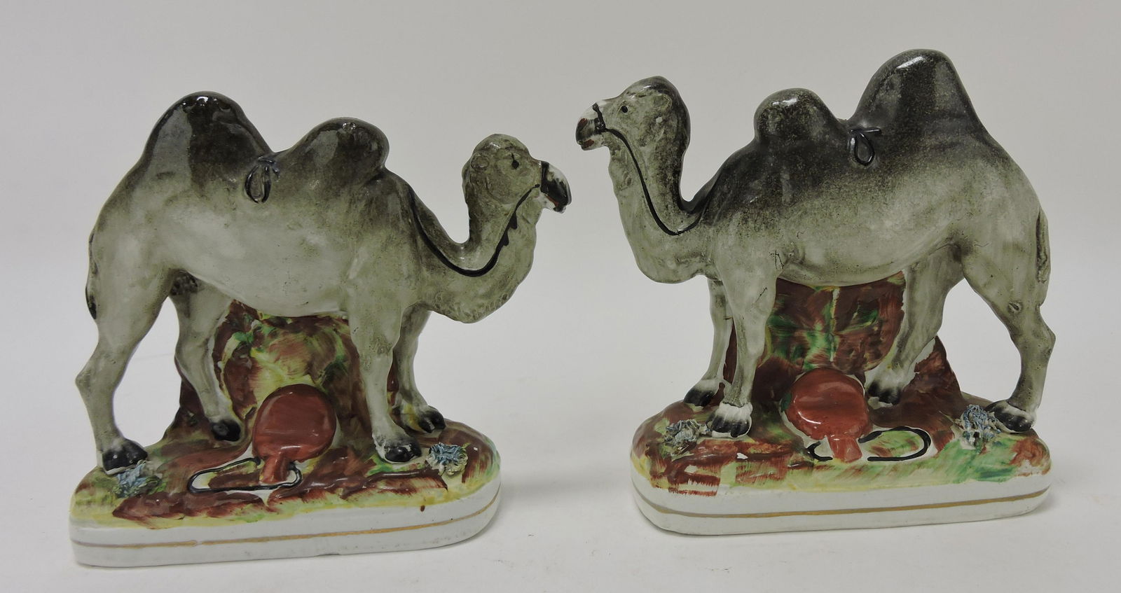 Staffordshire pair of camel figures, (1 of 2)