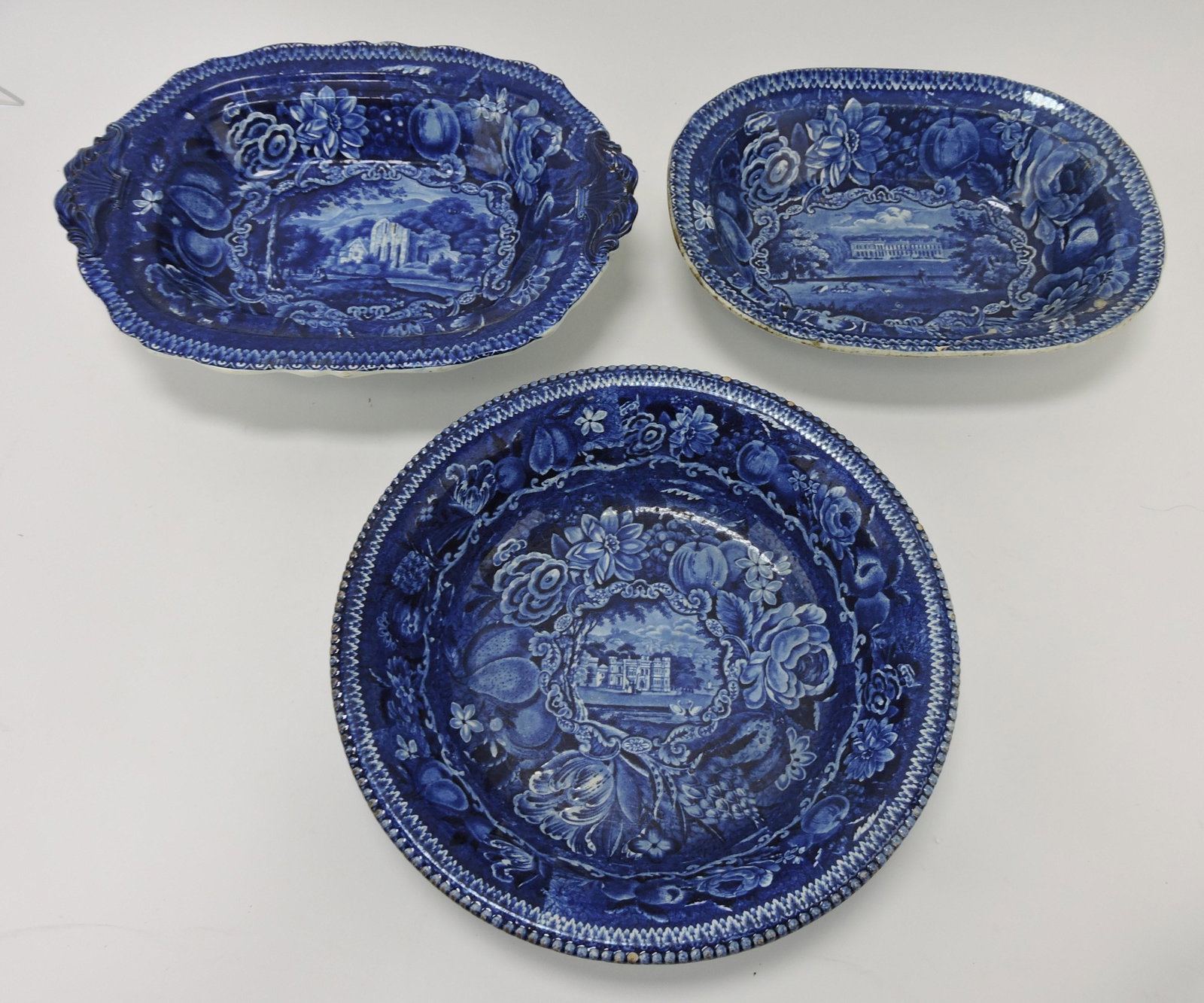 Staffordshire transferware blue and: white lot of 3 pieces: Valley Crusis Abbey casserole base, Boughton House oval bowl (hairline), and Warleigh House 11" bowl (minor wear)