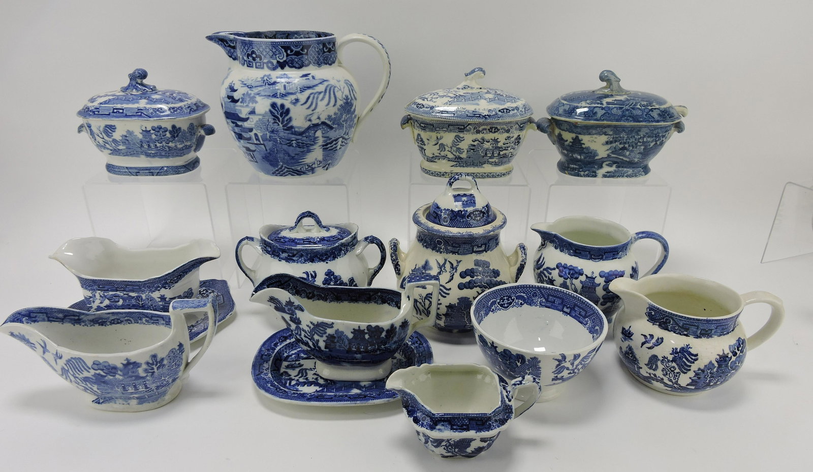 English Blue Willow lot of 13 pieces:: sauce tureens, pitchers, sugars, creamers, sauce boats, and bowl