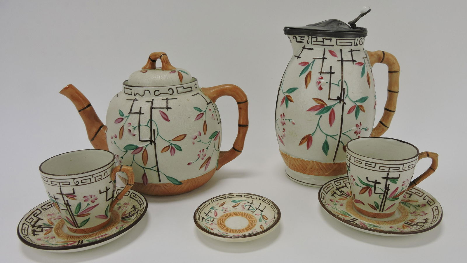 Brownhills Pottery majolica teapot,: pewter top syrup pitcher, 2 cups & saucers, and one butter pat