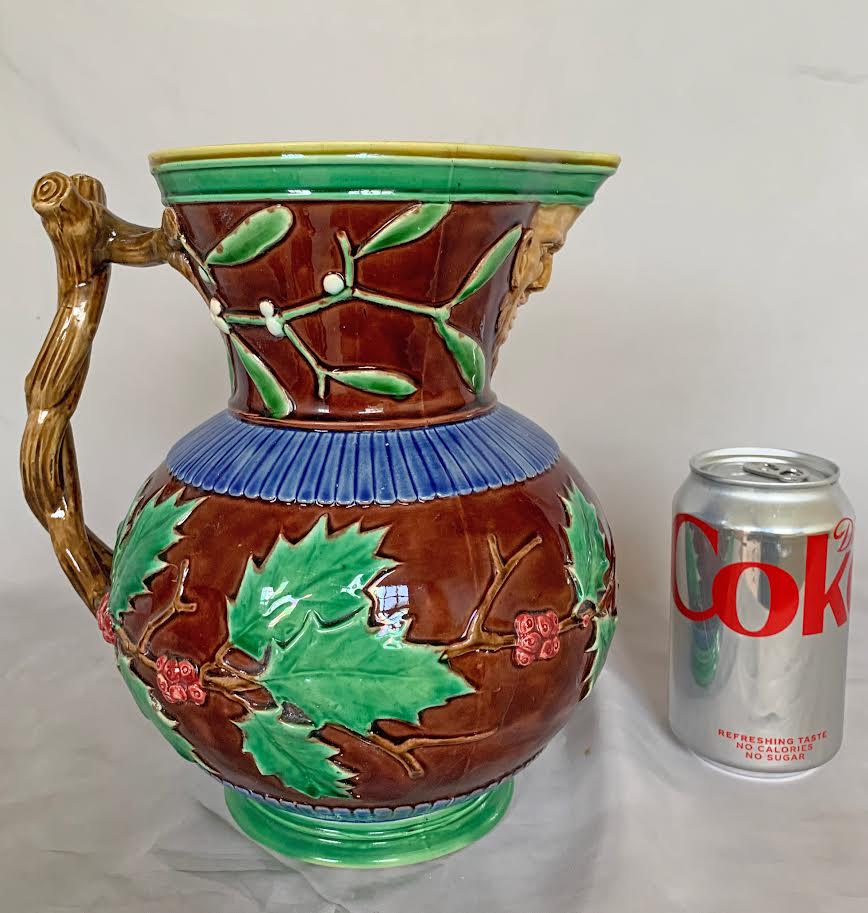 Very large Minton “Christmas” pitcher,: 10"h shape no. 580, decorated with holly, the neck with mistletoe with a mask handle under the spout and an entwined twig handle