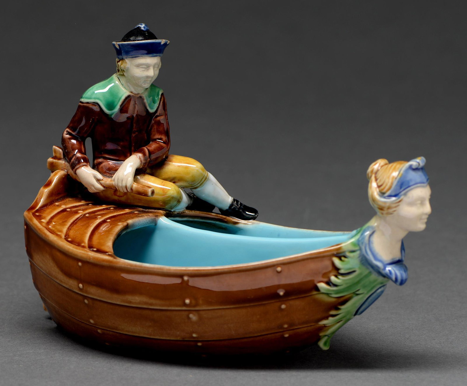 Minton majolica boat modelled as a: row boat with female figure head, a boy at the rear holding a rudder, 4 3/4"h, 6 3/4"w, 3 1/2"deep, pattern number 507