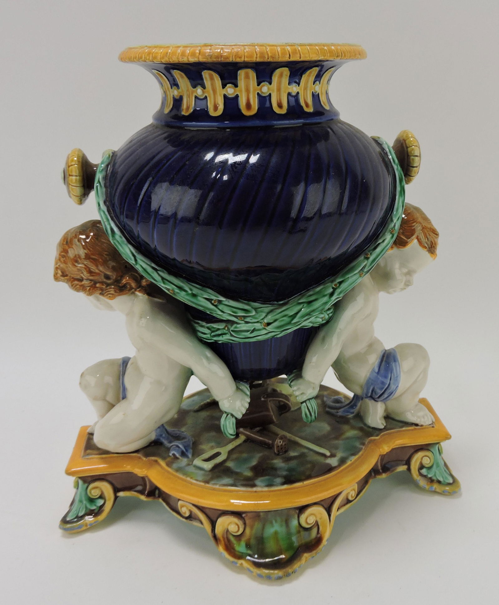 Wedgwood majolica 'Boucher' vase,: cobalt amphora vase with laurel swags supported by two putti, 11"h, 10"w
