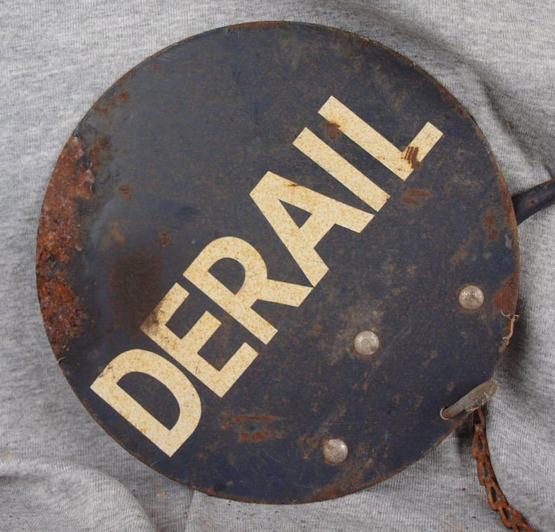Metal sign on arm "DERAIL", 2 sided, rust : Metal sign on arm "DERAIL", 2 sided, rust