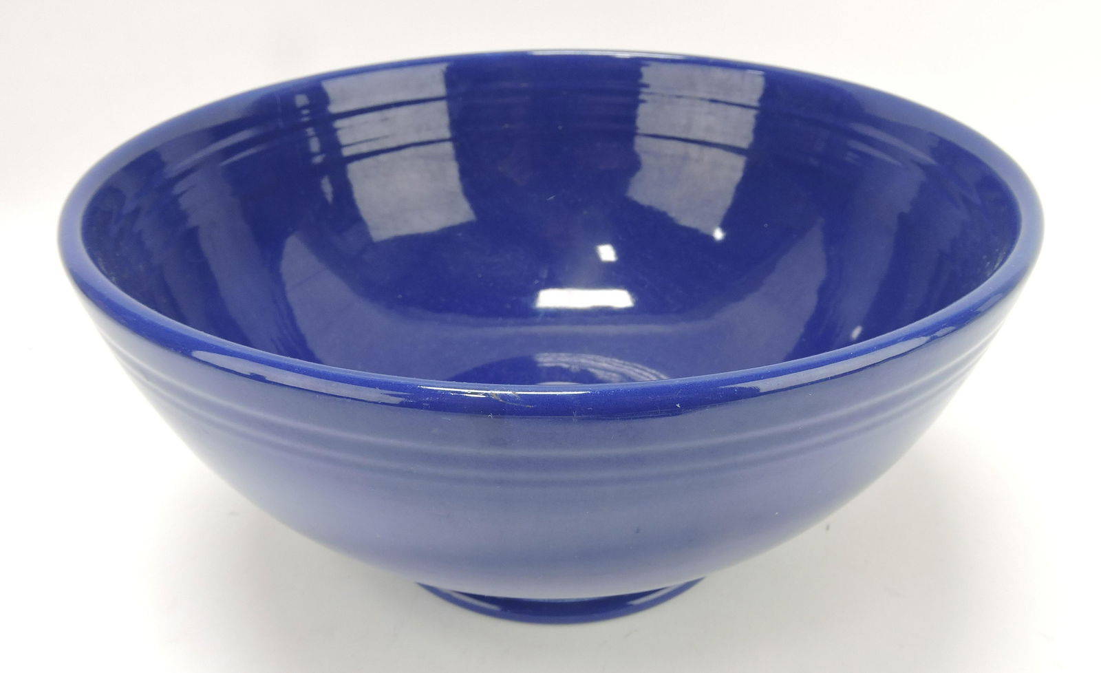 Fiesta footed salad, cobalt, minor rim: nick and utensil wear