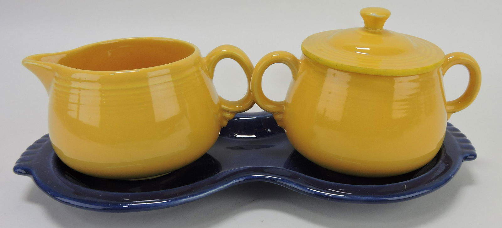 Fiesta yellow cream & sugar on: cobalt figure 8 tray