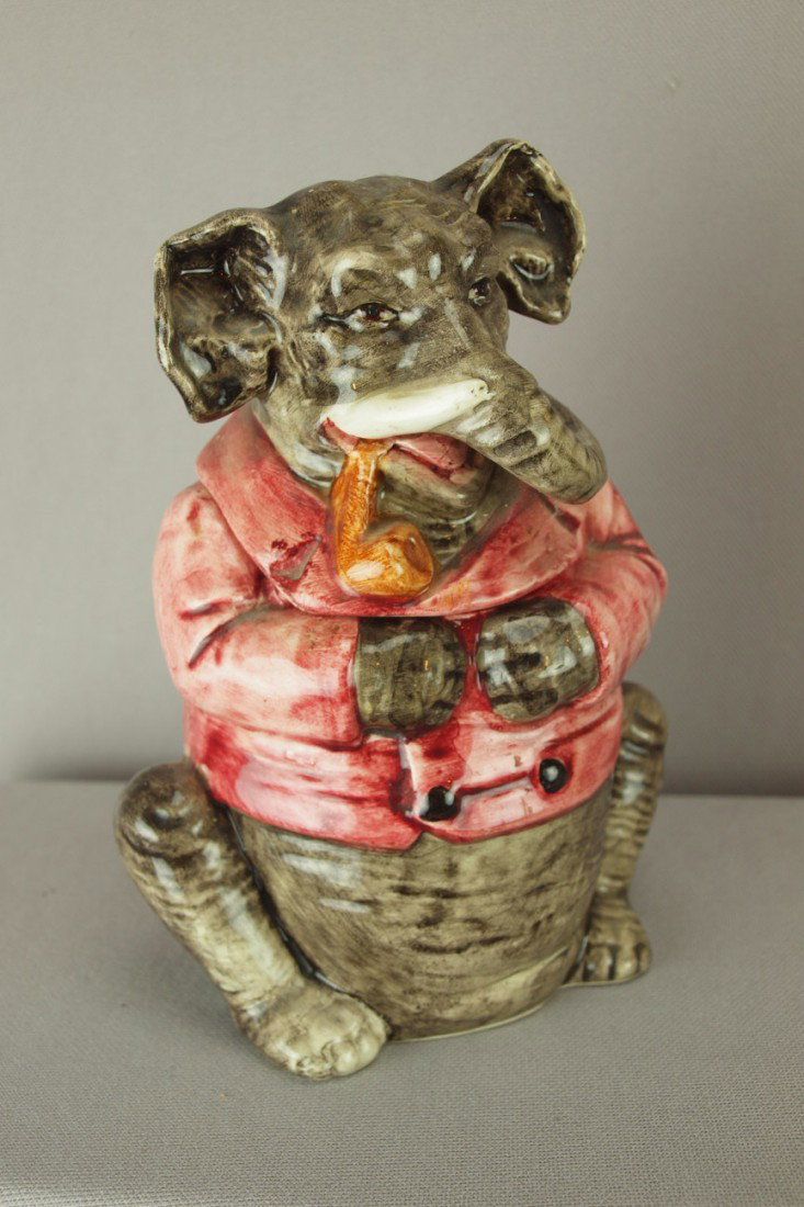 Continental elephant with pipe and red smoking jac: Continental elephant with pipe and red smoking jacket figural majolica humidor, rim chip to lid, 7"