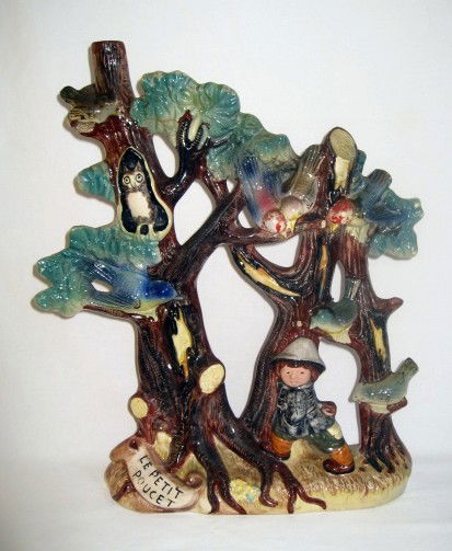 Large French majolica liquor bottle representing ": Large French majolica liquor bottle representing "Le petit Poucet" rom Charles Perrault tales, 14"h, very rare form