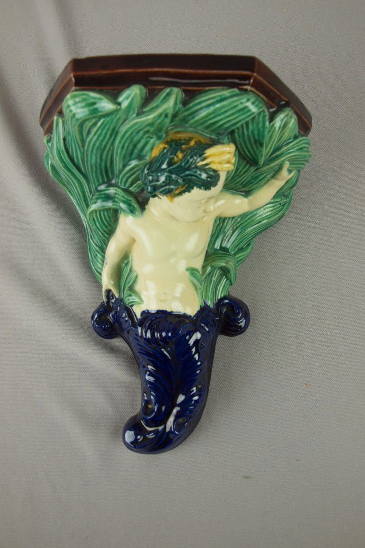 Thomas Sergent majolica wall bracket shelf with pu: Thomas Sergent majolica wall bracket shelf with putti, 9"h, 7"w