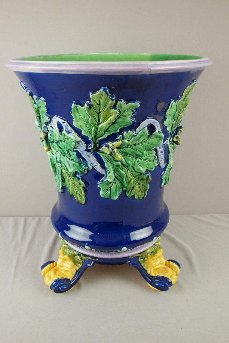 Large majolica cobalt jardiniere and stand with ma: Large majolica cobalt jardiniere and stand with mask feet, jardiniere decorated with oak leaf and acorn motif, lavender accents, professional rim and hairline repair, 21"h, 16 1/2"d