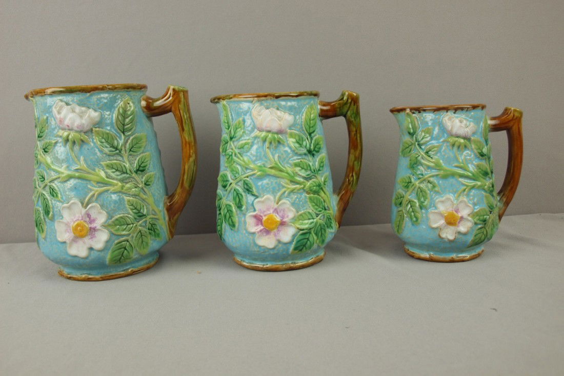 GEORGE JONES majolica set of 3 turquoise wild rose: GEORGE JONES majolica set of 3 turquoise wild rose graduated jugs, great color, 6 3/4", 6" and 5 1/2", professional rim repair to small one