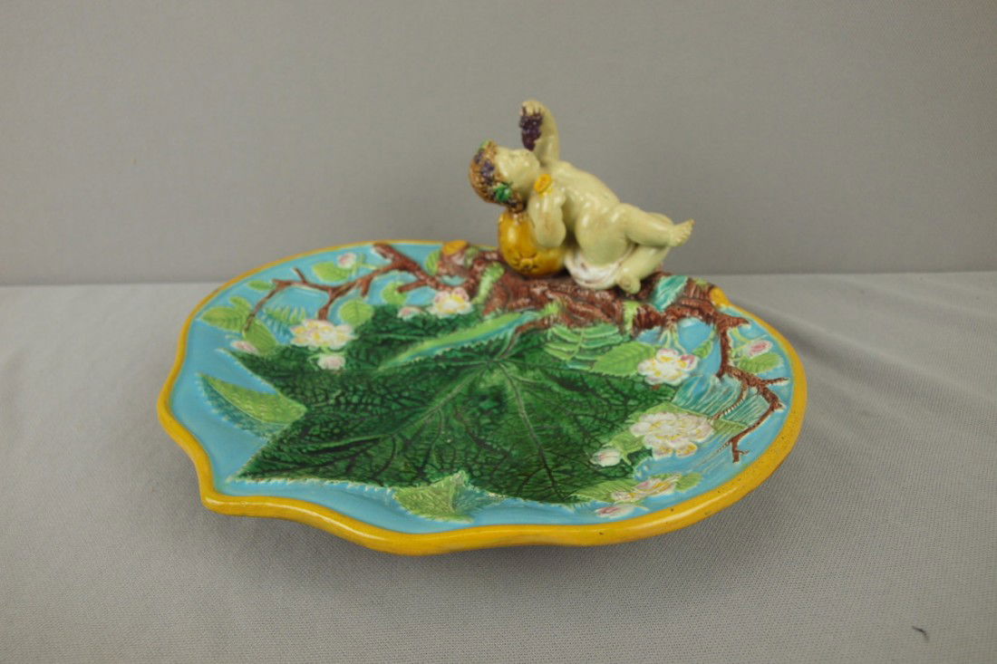 GEORGE JONES majolica serving tray with putti eati: GEORGE JONES majolica serving tray with putti eating grapes handle, 10 1/2"w, professional repair to putti's arm